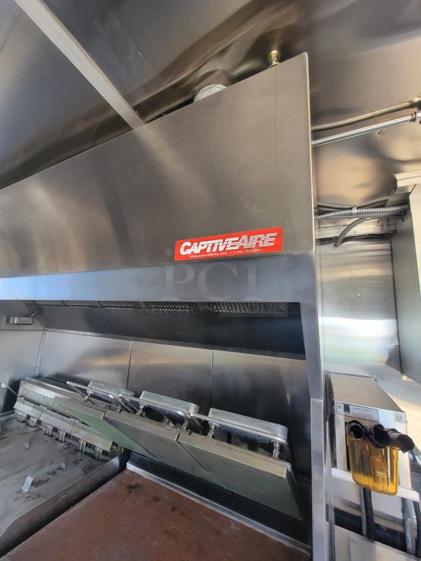 CaptiveAire commercial kitchen hood system, stainless steel, featuring company logo and website. Appears in good condition.