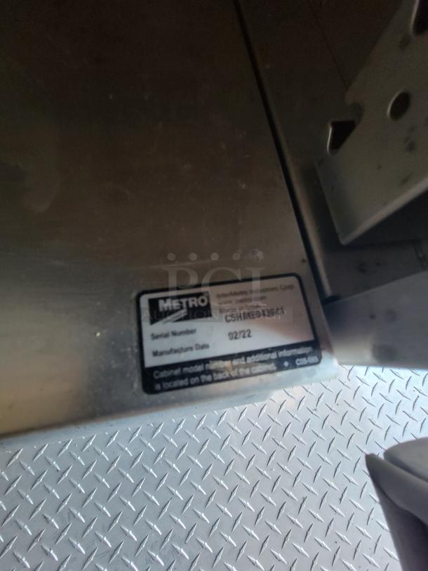 Metro industrial cabinet label showing serial number CSHME043091 and manufacture date 02/22.