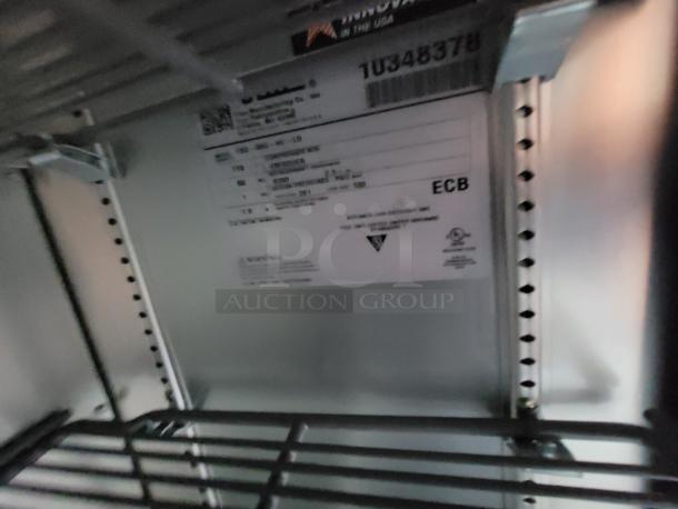 Electrical panel interior with label indicating model DSII-IL-D, serial number 10348378. Features metal shelving.