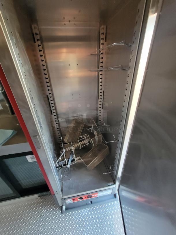 Commercial stainless steel warming cabinet, internal racks, temperature control panel, used condition, spacious interior.