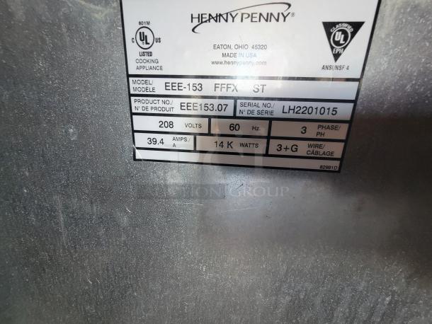 Henny Penny EEE-153 appliance label showing model, serial number LH2201015, 208 volts, and 14K watts. Made in USA.
