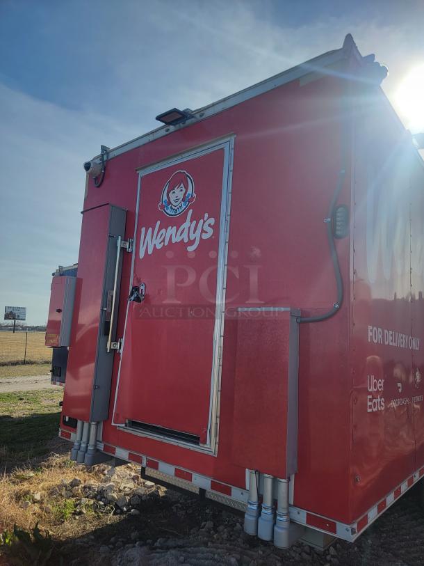 Red Wendy's delivery trailer with logo, featuring external utility boxes and delivery service logos. Good condition.