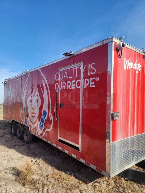 Red Wendy's food trailer with logo and "Quality Is Our Recipe" slogan. Three axles, metal siding, minimal wear.