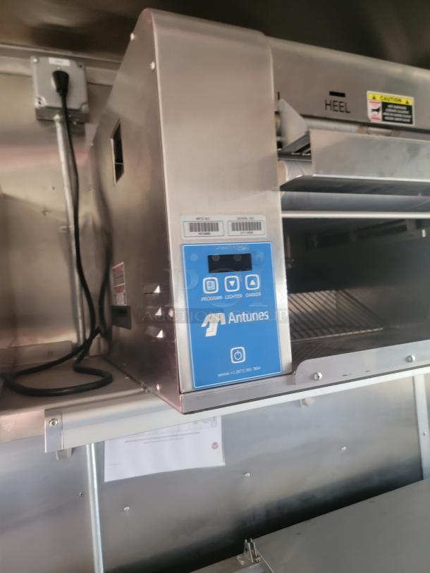 Antunes commercial kitchen appliance with control panel, stainless steel finish; visible labels indicate settings and serial information.