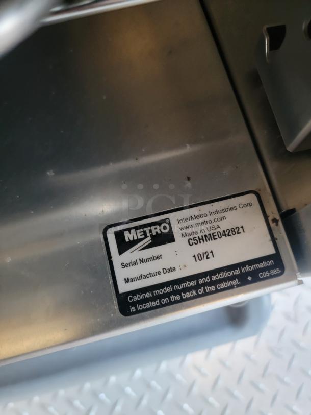 Metro cabinet label with serial number C5HME042821, manufactured 10/21, by InterMetro Industries Corp, USA.