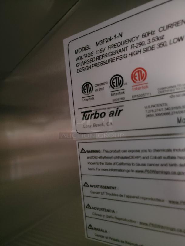 Label on Turbo Air model M3F24-1-N showing voltage, refrigerant, and design pressure details; includes warning for chemical exposure.