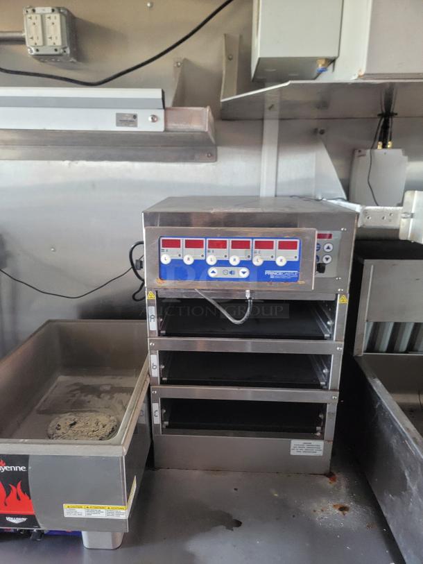 Commercial stainless steel food warmer with three shelves, digital controls, and Prince Castle branding, in used condition.