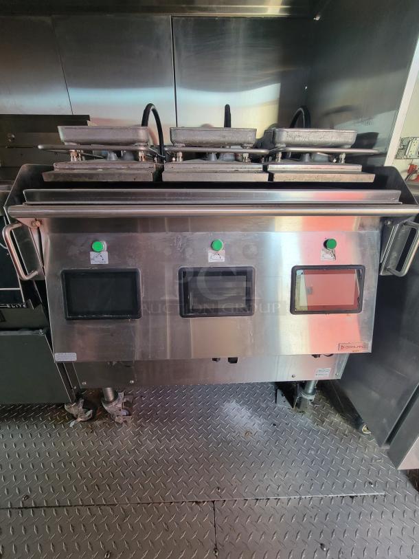Stainless steel commercial grill with dual cooking surfaces, labeled "Dorlano," on wheeled base, in used condition.