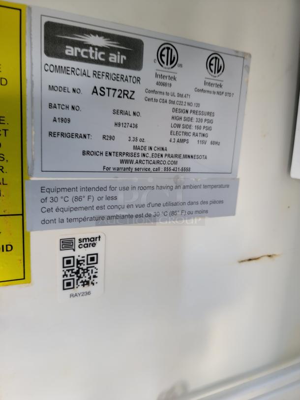 Arctic Air commercial refrigerator model AST72RZ label with specs. Includes serial H9127436, refrigerant R290, and QR code.