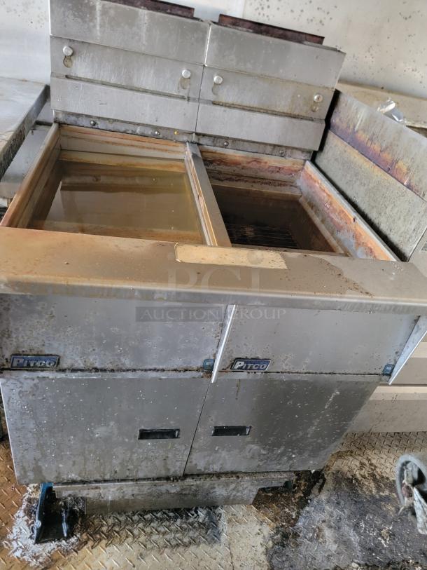 Pitco commercial deep fryer, dual vats, stainless steel, visible wear and rust, requires cleaning. Suitable for high-volume use.