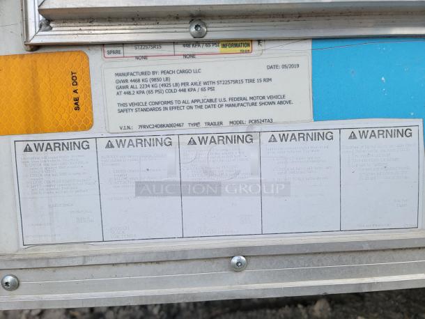 Peach Cargo trailer safety and specification labels; GWR 4686 kg, model PC8524TA3, VIN: 7FRVC24DBKA002467, and warnings.