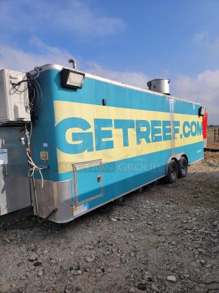Mobile kitchen trailer with "GETREEF.COM" branding, tow hitch, vents, and air conditioning unit. Blue and yellow exterior, dual axles.