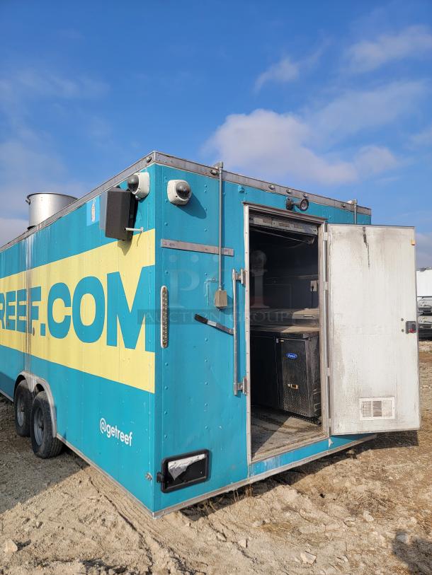 Blue mobile kitchen trailer with "getreef.com" branding, open side door, visible equipment inside. Good condition.