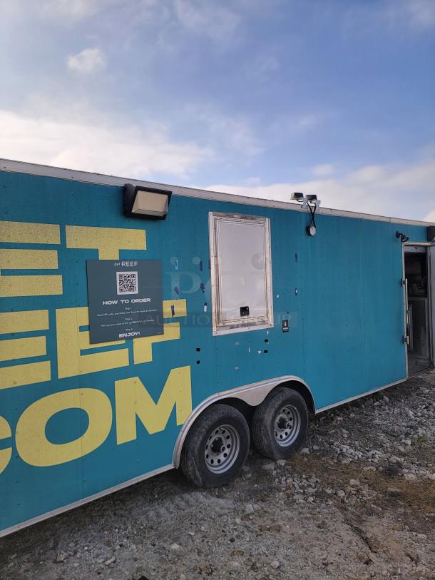 Mobile food trailer with "getREEF" branding, blue exterior, and a QR code for ordering. Dual axle, used condition.