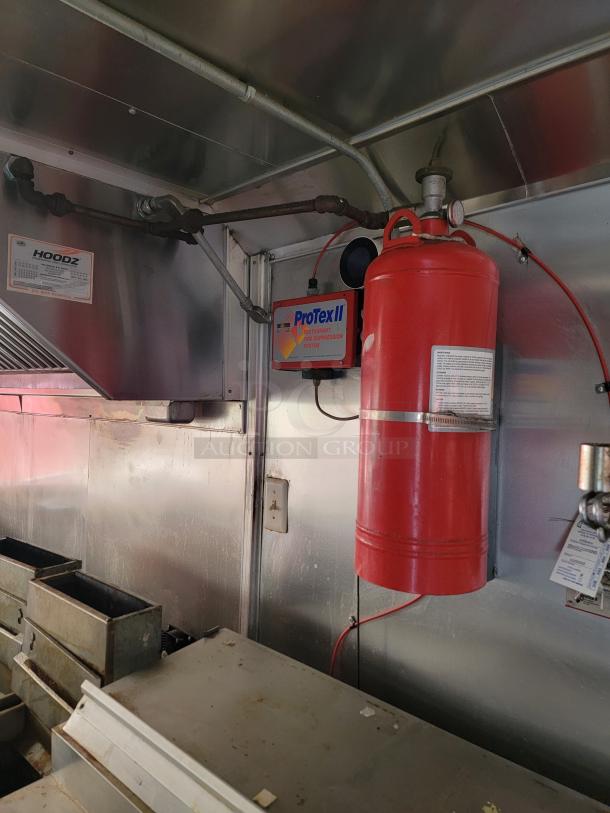 ProTex II fire suppression system in stainless steel kitchen setup, includes red cylinder and control box. Good condition, essential for safety.