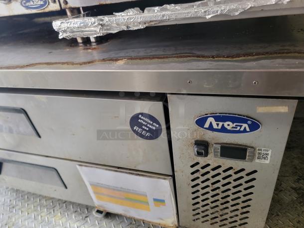 Atosa commercial kitchen equipment with digital controls, showing signs of wear. Features ventilation and brand logo.