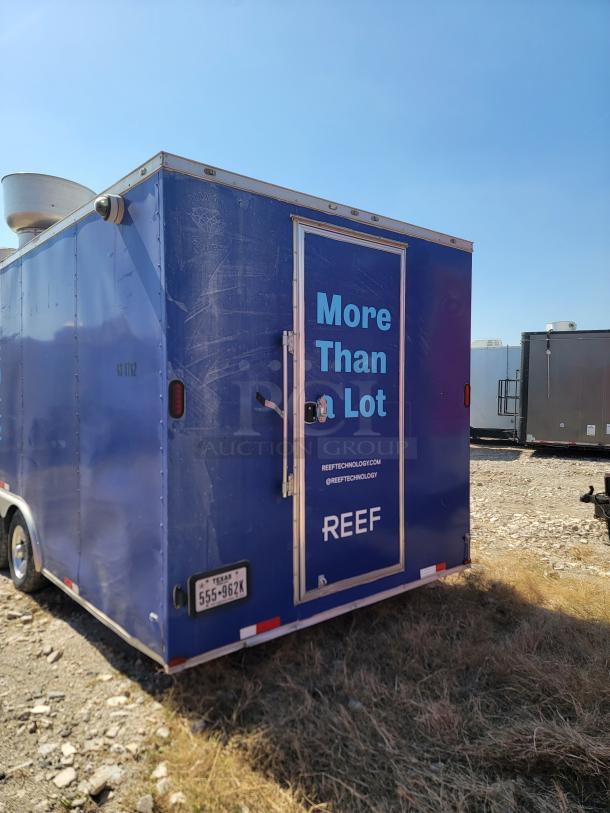 Blue mobile kitchen trailer by REEF, featuring "More Than a Lot" branding. Visible wear, Texas license plate, and side vent.