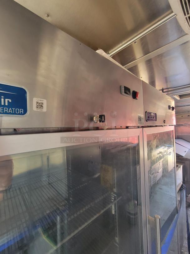 Stainless steel commercial refrigerator with glass doors, interior shelves, and digital controls. Label reads "Refrigerator."