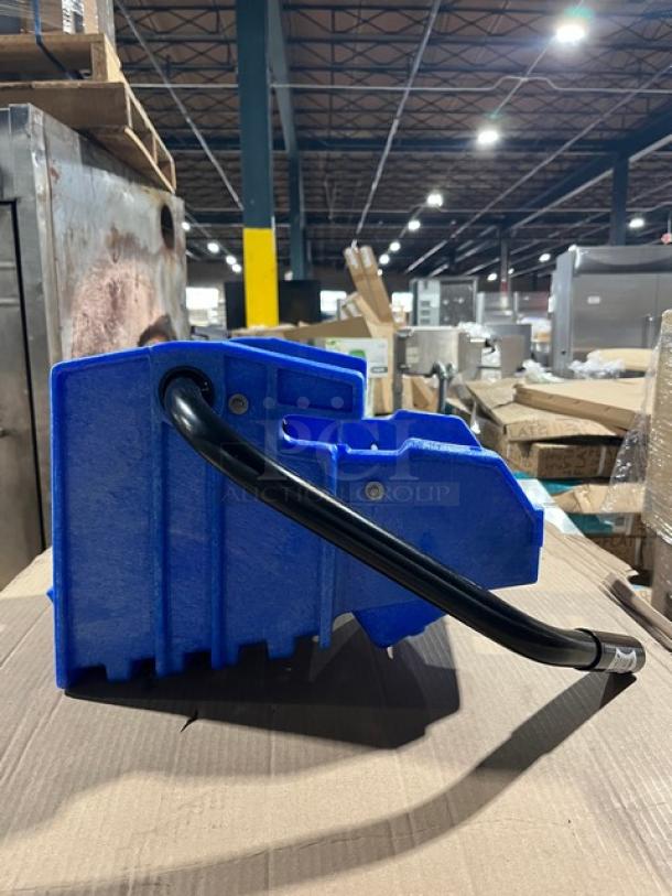 Brand new commercial blue plastic mop side press wringer, Model WH6000B, on a cardboard surface, excellent condition.