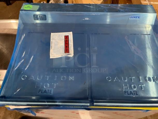 Dinex DXPSBH2P stainless steel plate heater dispenser, 2-silo, on casters, model SN: 2411232, 208V 1 Phase, "Caution Hot" label.