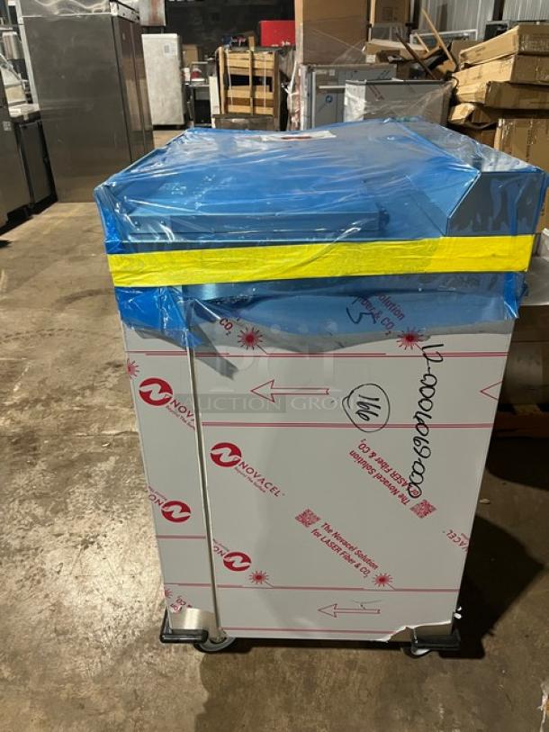 Dinex DXPSBH2P stainless steel plate heater dispenser, 2-silo model, new condition, on casters, wrapped in protective covering.