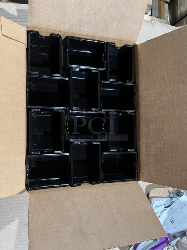 Brand new commercial black condiment caddie, model SC-66, in open box, featuring multiple compartments.