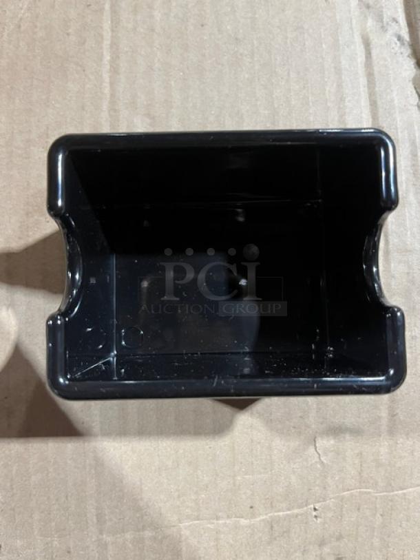 Brand new commercial black condiment caddie, model SC-66, in pristine condition on cardboard surface.