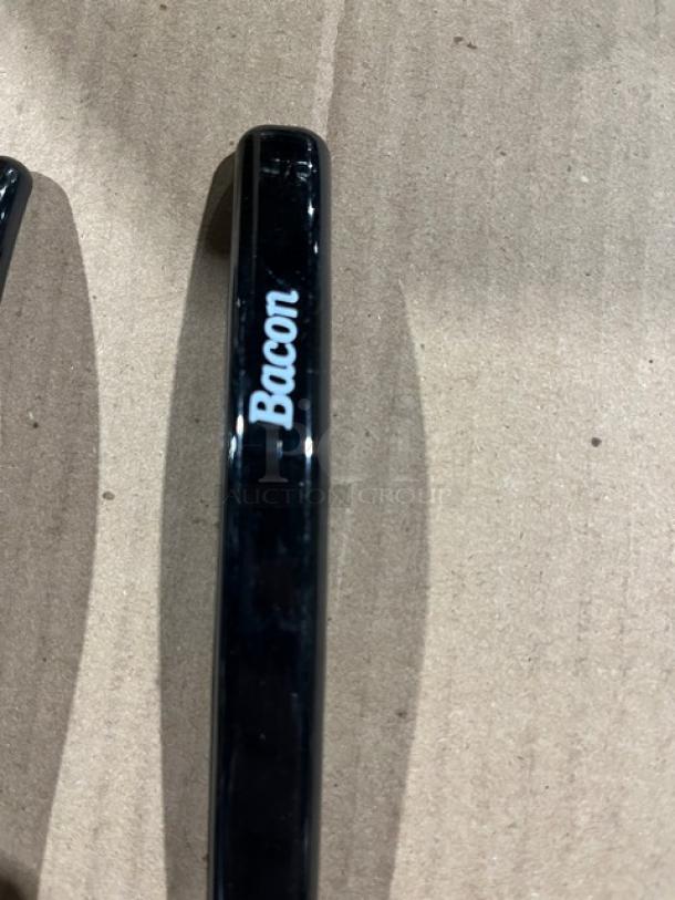 Brand new Carlisle NSF2 black ladle with "Bacon" label on handle, pristine condition, ideal for commercial use.