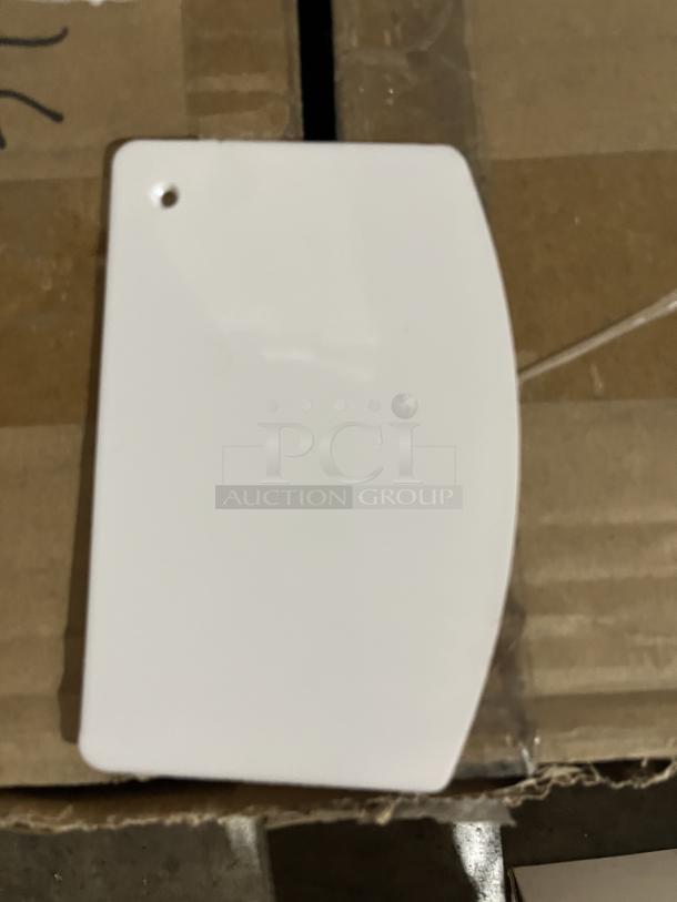 Three packs of commercial white Apoxy dough scrapers, new condition, rectangular with rounded edges and hole for hanging.