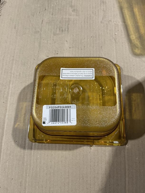 Brand new Rubbermaid Commercial Amber High Heat 1/6 Size Food Pan, Model FG204P00AMBR, with barcode label shown.