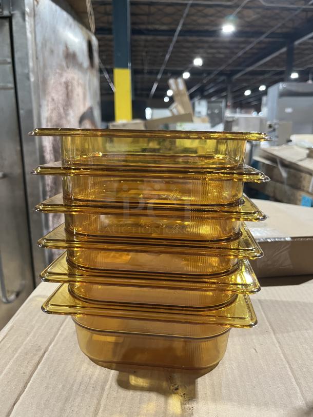 BRAND NEW Rubbermaid Commercial Amber High Heat 1/6 Size Food Pan, Model FG204P00AMBR, stack of six on cardboard.