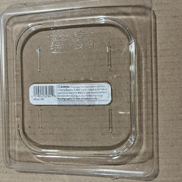 Cambro Camwear clear polycarbonate 1/6 size food pan cover, model 60CWC135, new condition, with safety warning label.