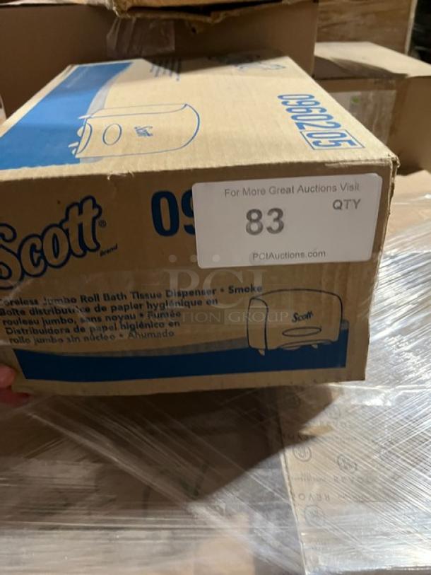 Brand new Scott Model 09602 Jumbo Roll Bath Tissue Dispenser in box. Smoke black color. Outer box shows branding and model number.