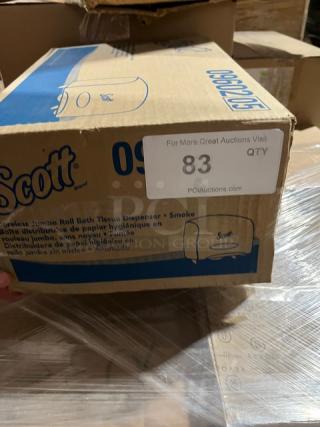 Brand new Scott Model 09602 Jumbo Roll Bath Tissue Dispenser in box. Smoke black color. Outer box shows branding and model number.