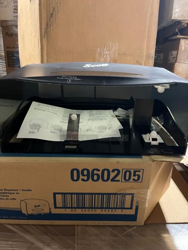 Brand new Scott 09602 jumbo roll bath tissue dispenser, smoke black, with packaging and installation instructions.
