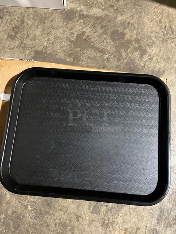 Brand new Carlisle black 14"x18" fast food/serving tray, Model CT141803. Textured surface, ideal for commercial use.