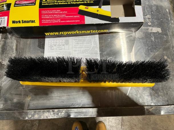 Brand new Rubbermaid Commercial 18" broom head with polypropylene bristles, yellow base; packaging visible.
