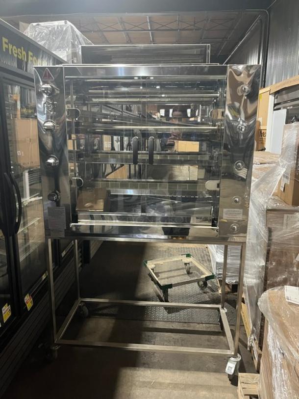 BRAND NEW Rotisol 11604 natural gas rotisserie oven with stainless steel body, tempered glass doors, and casters. Model SN: 9409.