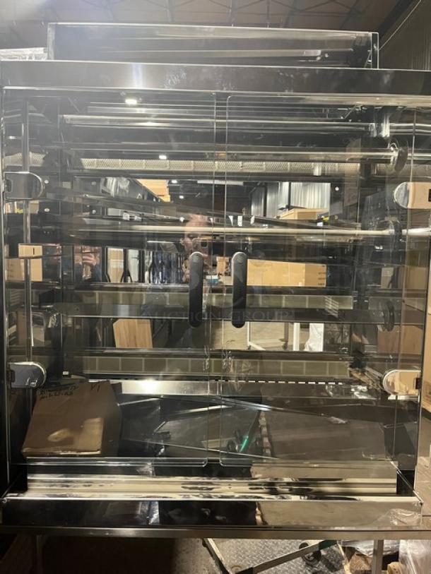 Brand new Rotisol stainless steel gas rotisserie oven, model 1160.4, with tempered glass doors and casters.