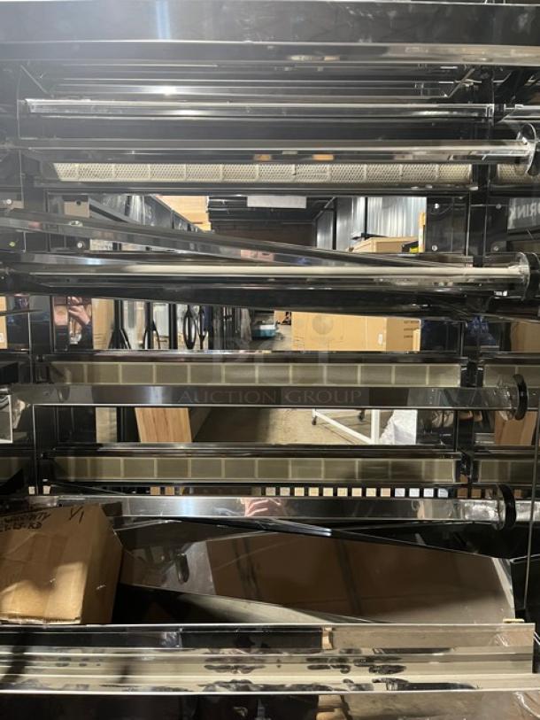 Brand new Rotisol 1160.4 stainless steel natural gas rotisserie oven with tempered glass doors, on casters. Model SN: 9409.