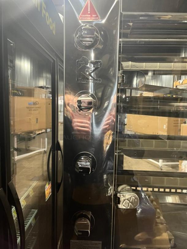 Rotisol commercial stainless steel rotisserie oven, model 1160.4, features tempered glass swing doors, new condition, on casters.