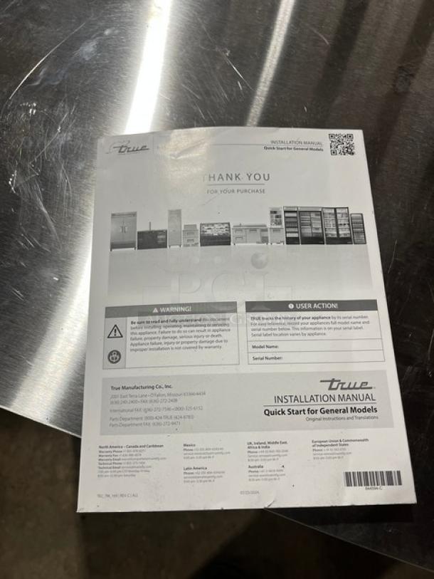 True installation manual on stainless steel surface. Key information includes model TUC-27D-2-HC, SN: 11059798, and user instructions.