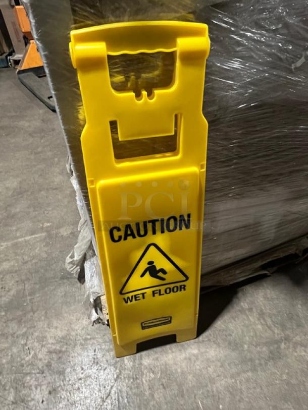 Yellow Rubbermaid Commercial wet floor sign, model 6114-77, leaning against shrink-wrapped pallet.