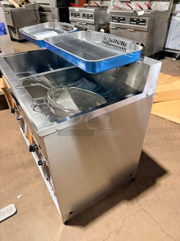 Brand new Goreous dual bay stainless steel electric deep fat fryer with cabinet base and legs; includes fry baskets.