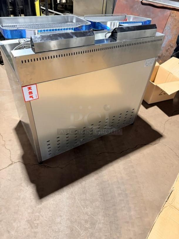 Brand new Goreous stainless steel dual bay electric deep fat fryer with cabinet base. Features leg supports, pristine condition.