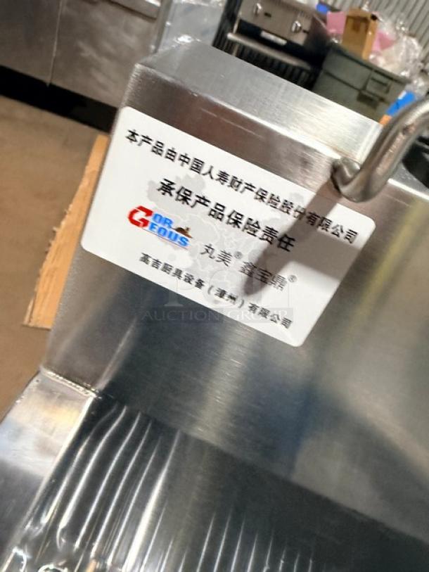 Brand new Goreous all stainless steel dual bay electric deep fat fryer with cabinet base and legs. Features quality assurance label.