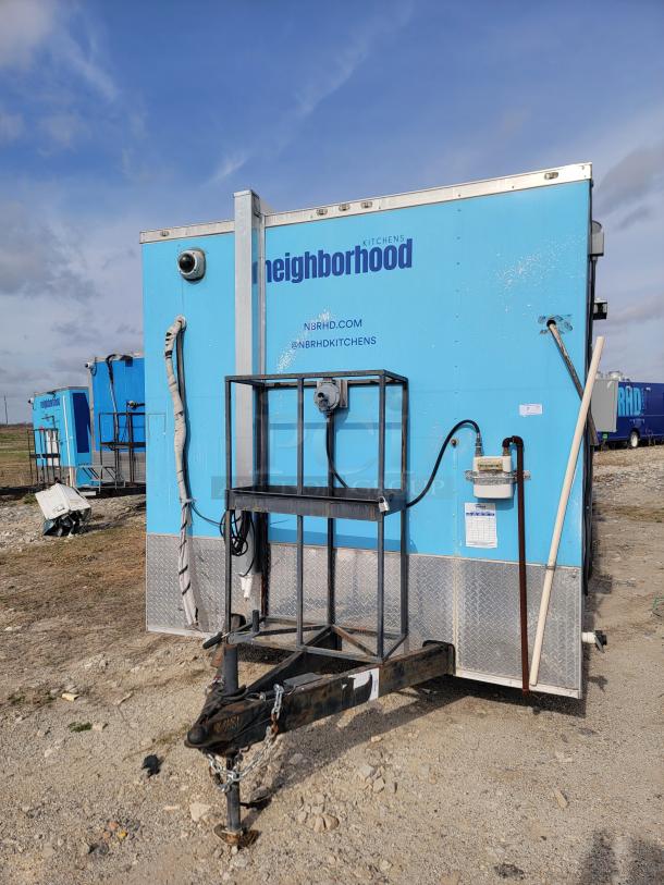 Blue mobile kitchen trailer by Neighborhood Kitchens. Features include utility hook-ups, reinforced frame, and branded exterior.