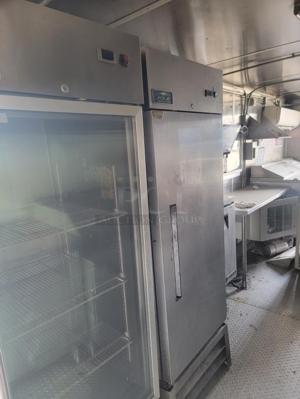 Commercial kitchen equipment, including an Arctic Air refrigerator and freezer. Stainless steel, used, with visible shelving and control panels.