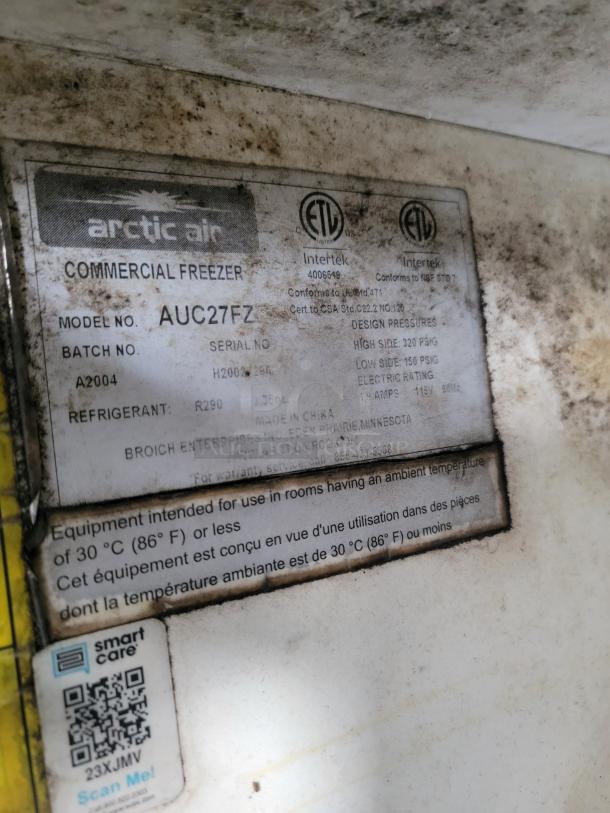 Arctic Air commercial freezer label, model AUC27FZ, batch A2004, uses R290 refrigerant, condition appears worn.