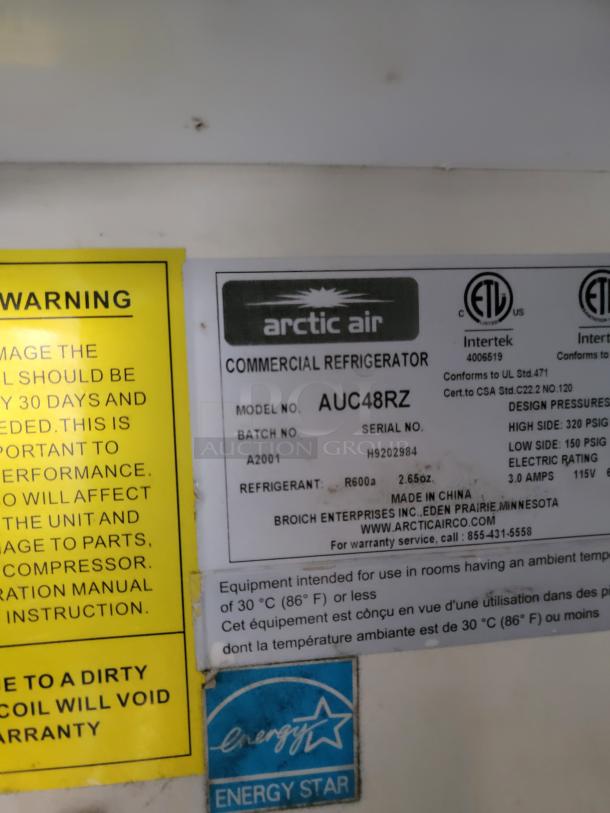 Arctic Air AUC48RZ commercial refrigerator label. Model details, batch, and serial number visible. Energy Star certified.